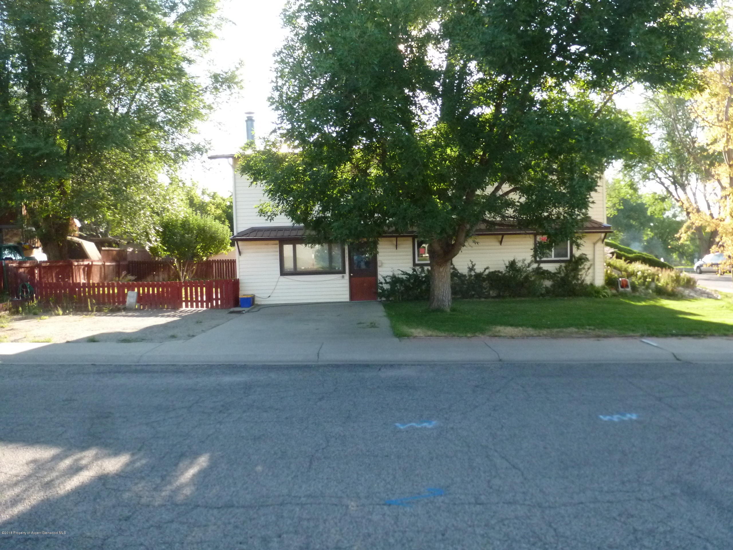810 East 5th Street Rifle, CO 81650 - Photo 2 of 13 a front view of a house with a yard and garage