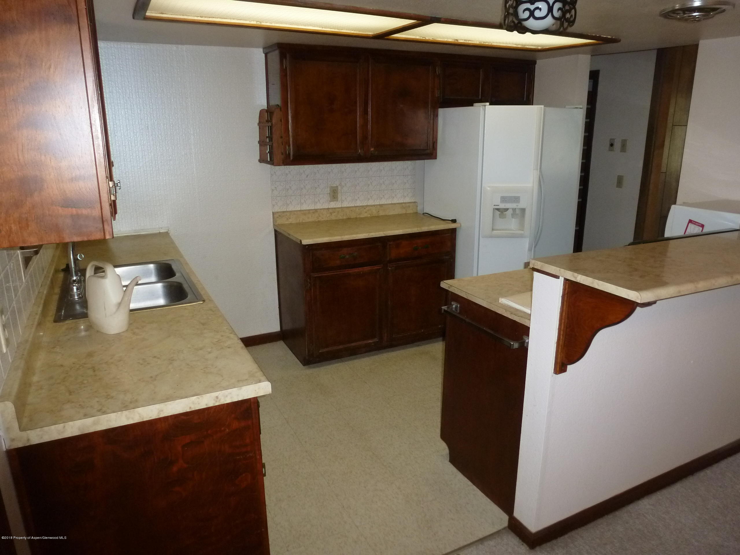 810 East 5th Street Rifle, CO 81650 - Photo 4 of 13 a kitchen with stainless steel appliances a refrigerator and a stove