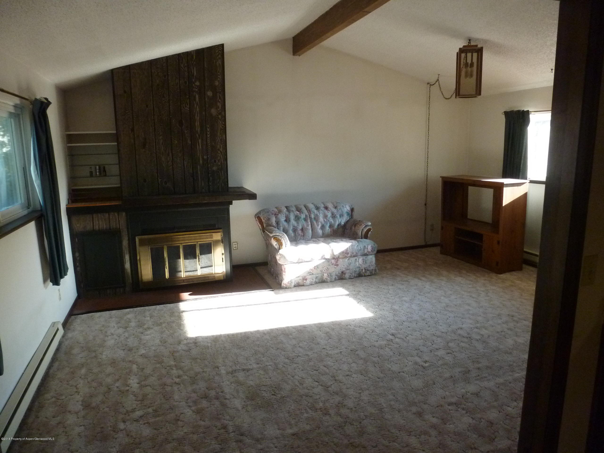 810 East 5th Street Rifle, CO 81650 - Photo 5 of 13 a living room with furniture and a fireplace