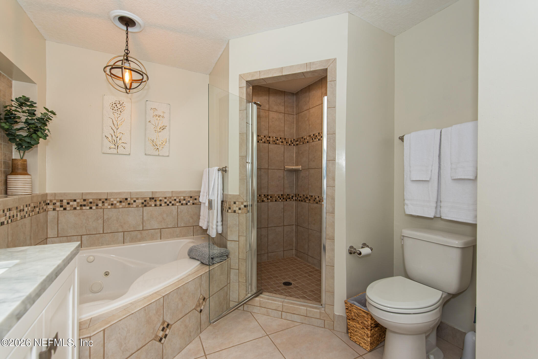 35 Oak Street St. Augustine, FL 32084 - Photo 18 of 43 a bathroom with a granite countertop toilet a sink and a bathtub