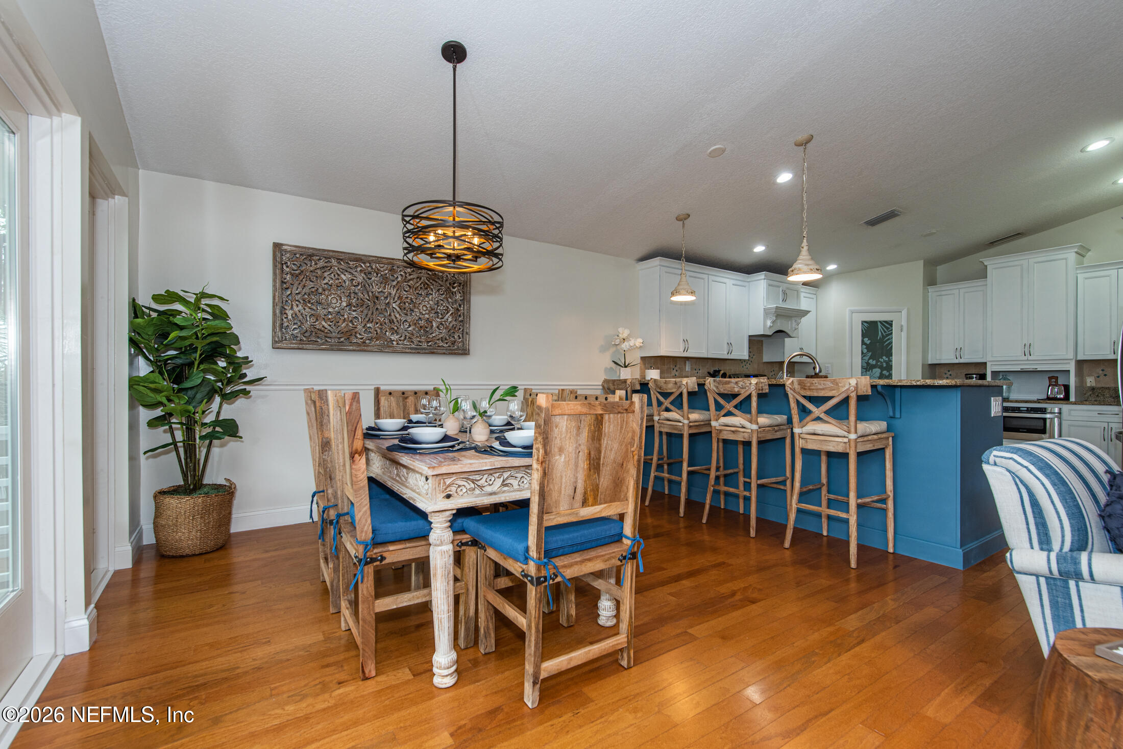 35 Oak Street St. Augustine, FL 32084 - Photo 26 of 43 a view of a dining room and livingroom with furniture wooden floor a rug a potted plant and a chandelier