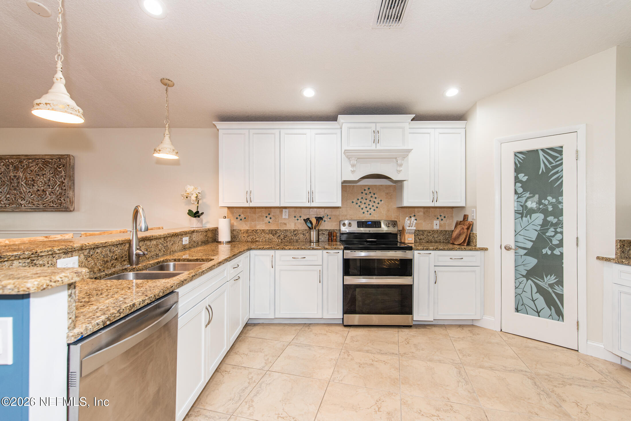 35 Oak Street St. Augustine, FL 32084 - Photo 29 of 43 a kitchen with a sink stove and cabinets