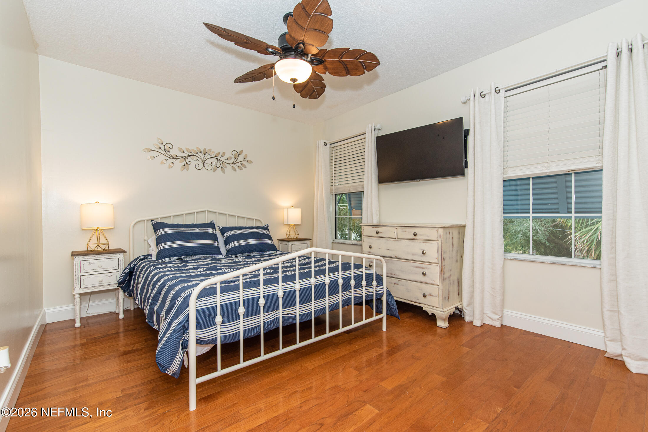 35 Oak Street St. Augustine, FL 32084 - Photo 31 of 43 a bedroom with a bed a flat screen tv and a window