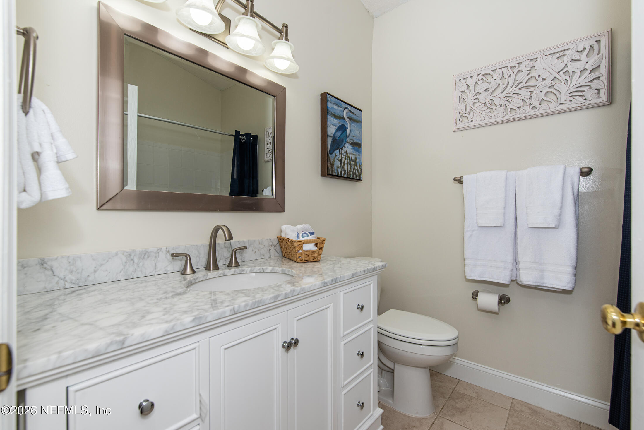 35 Oak Street St. Augustine, FL 32084 - Photo 34 of 43 a bathroom with a toilet a sink and mirror