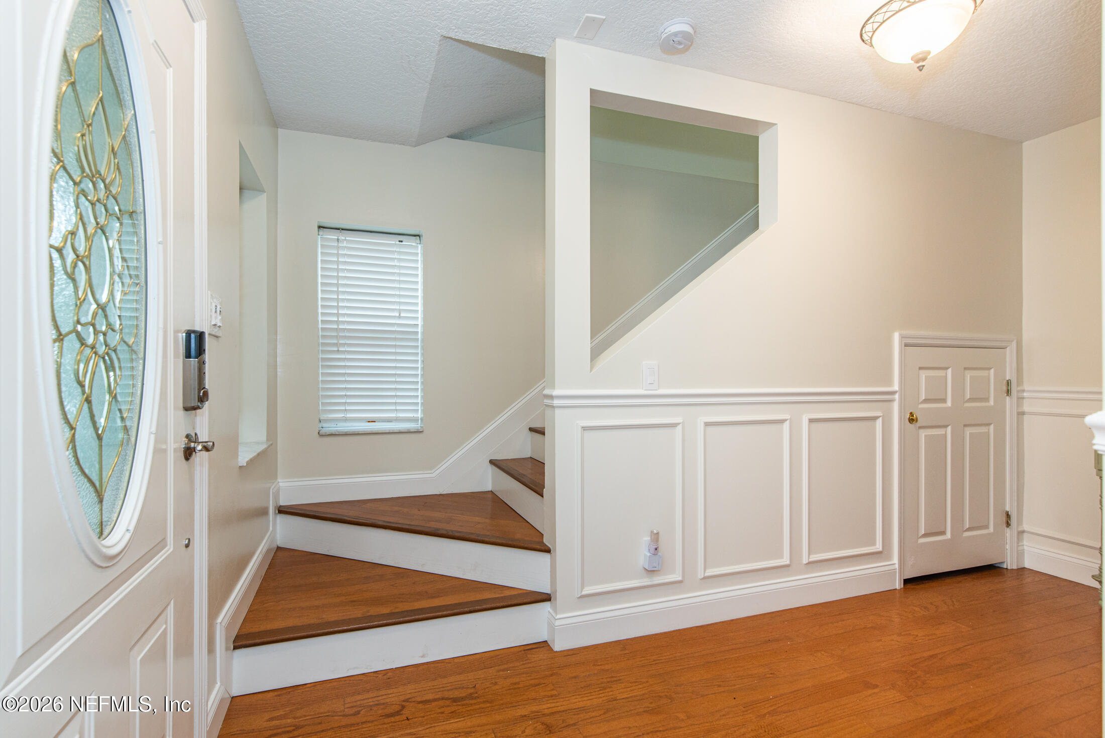 35 Oak Street St. Augustine, FL 32084 - Photo 10 of 43 an entryway with wooden floor and staircase