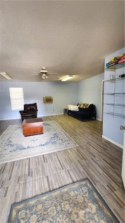 a bedroom with a bed and a wooden floor