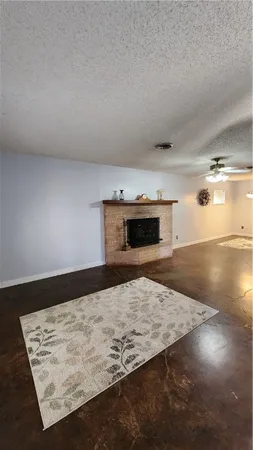 a living room with couch and a fireplace