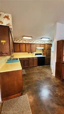 a view of a room with kitchen island stainless steel appliances wooden floor and living room view