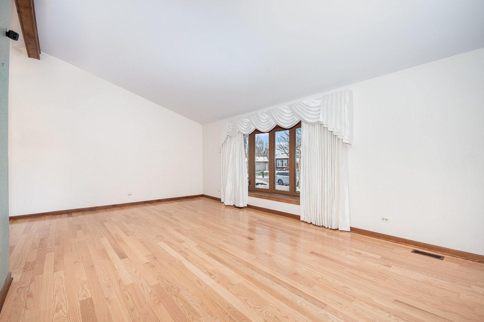 2880 Sun Valley Road Lisle, IL 60532 - Photo 11 of 29 a view of an empty room with a window and wooden floor