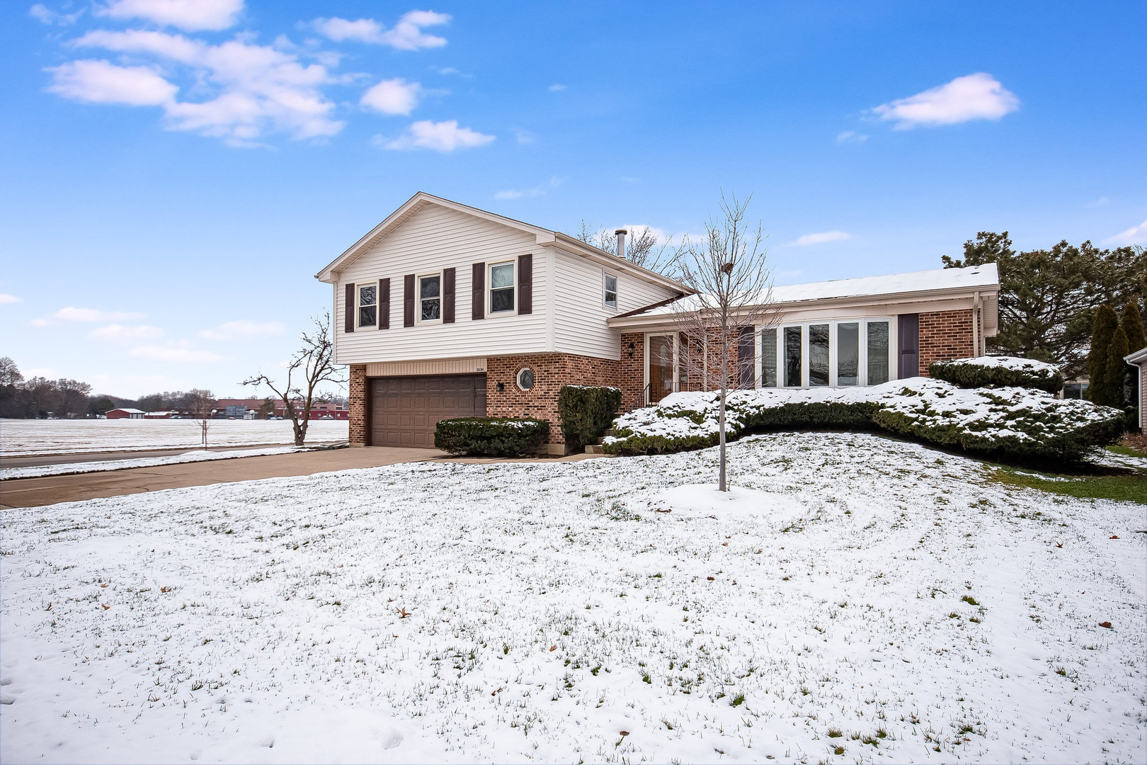 2880 Sun Valley Road Lisle, IL 60532 - Photo 2 of 29 a white house that has a tree in front of it