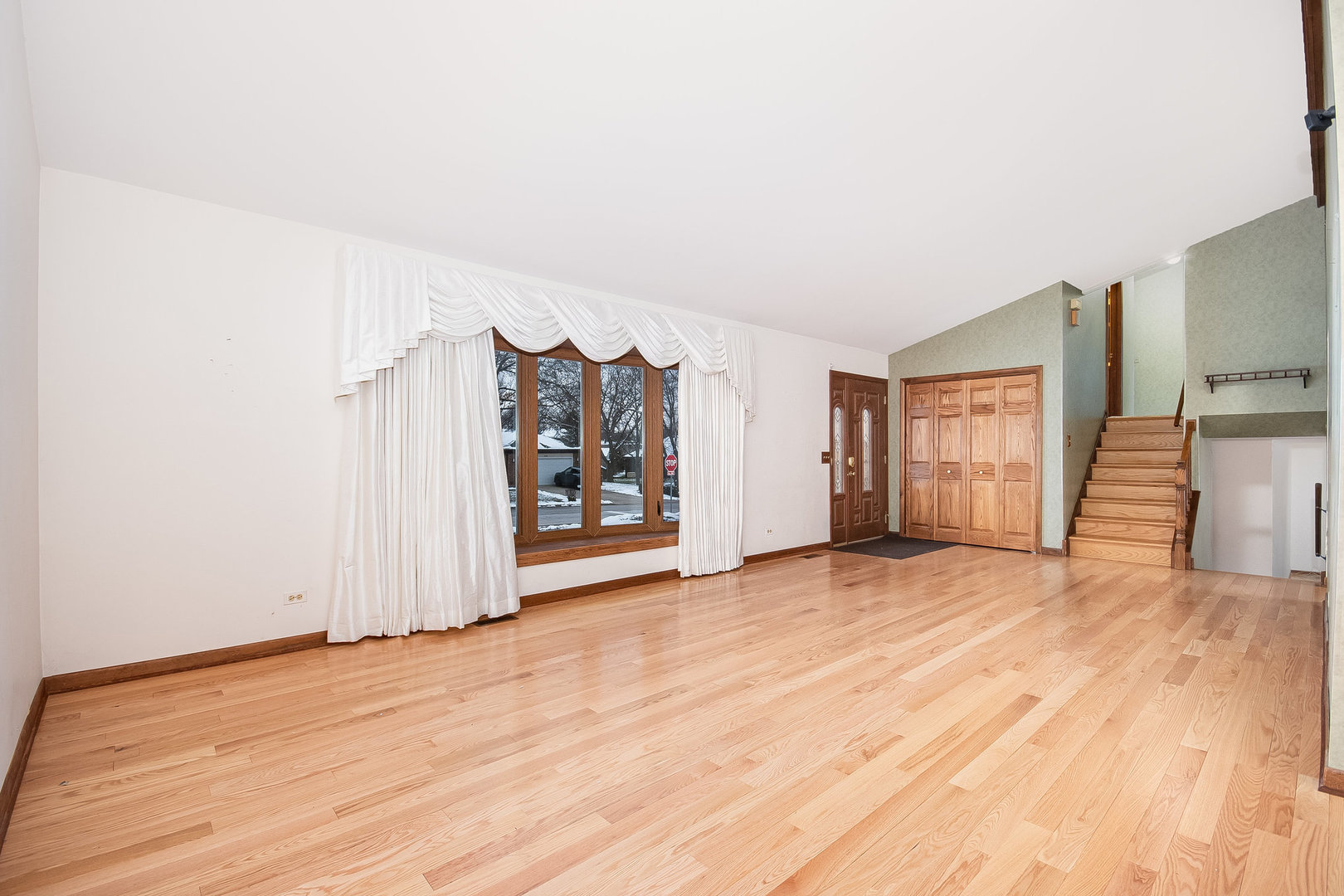 2880 Sun Valley Road Lisle, IL 60532 - Photo 3 of 29 an empty room with window and stairs