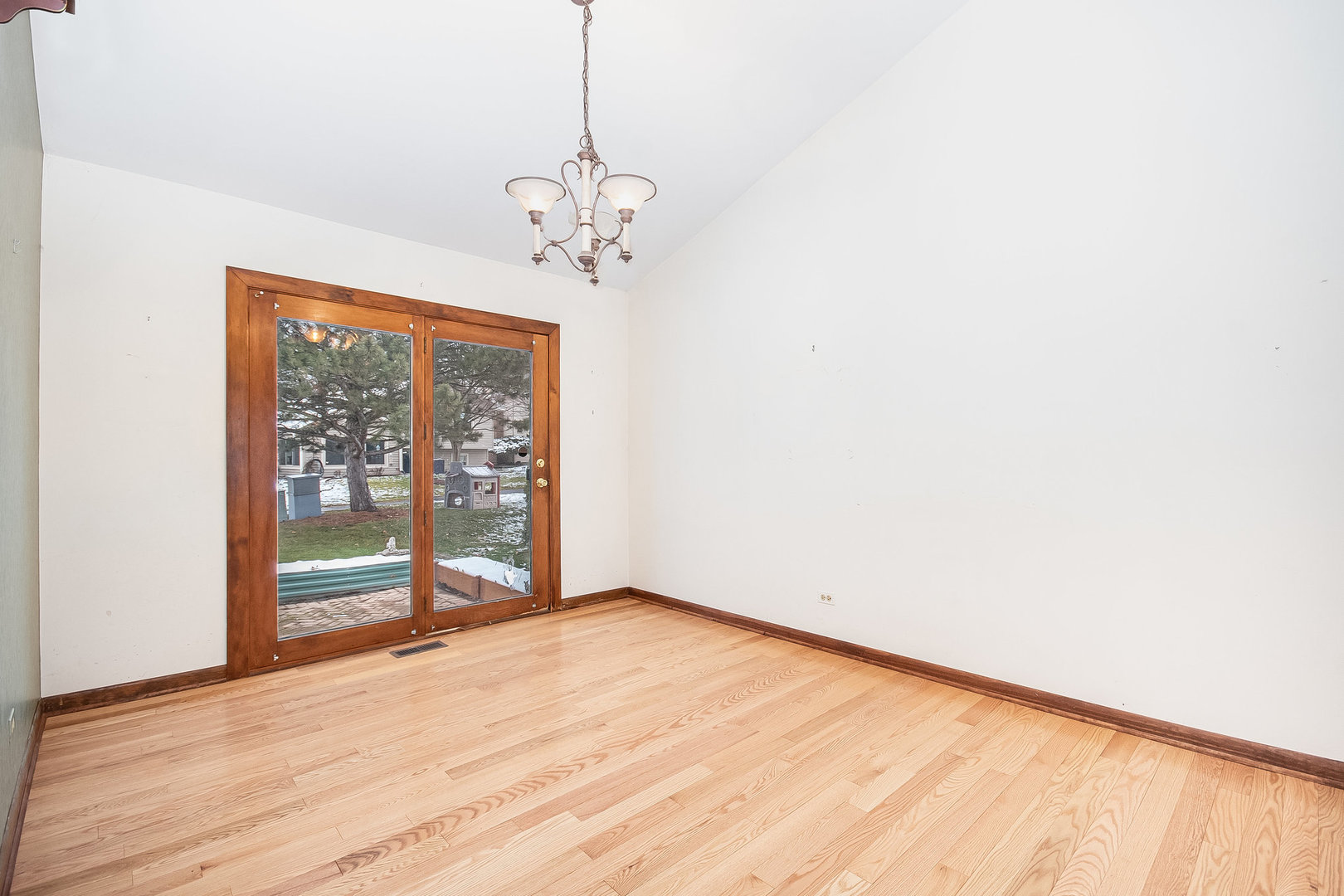 2880 Sun Valley Road Lisle, IL 60532 - Photo 5 of 29 a view of an empty room with wooden floor and a window