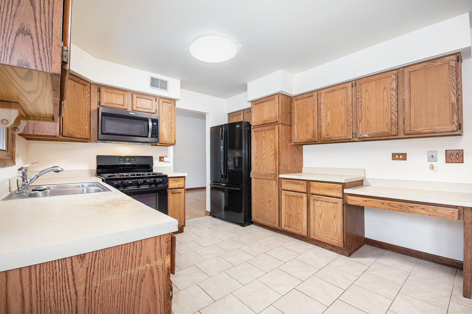 2880 Sun Valley Road Lisle, IL 60532 - Photo 6 of 29 a kitchen with granite countertop a refrigerator stove top oven and sink