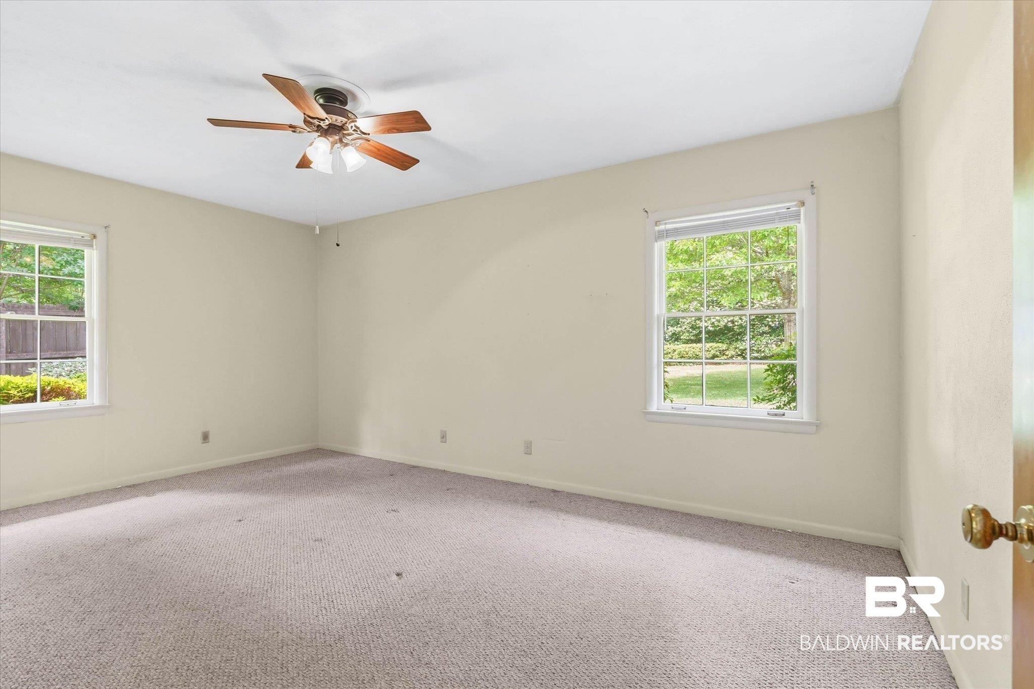1182 Ginger Drive Mobile, AL 36693 - Photo 18 of 37 Light-filled room featuring two windows, neutral wall tones, a ceiling fan with light fixture, and carpeted flooring