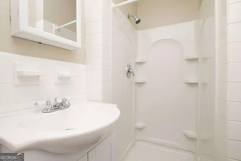 a bathroom with a sink and shower