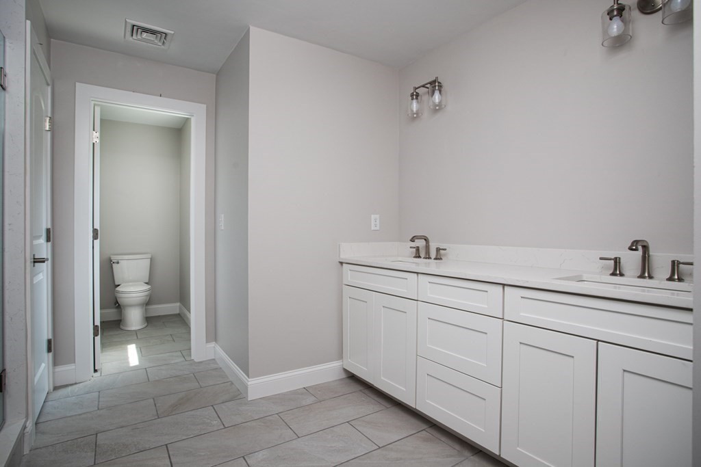 7 Julia Lane Assonet, MA 02702 - Photo 7 of 12 a spacious bathroom with a toilet sink and a mirror