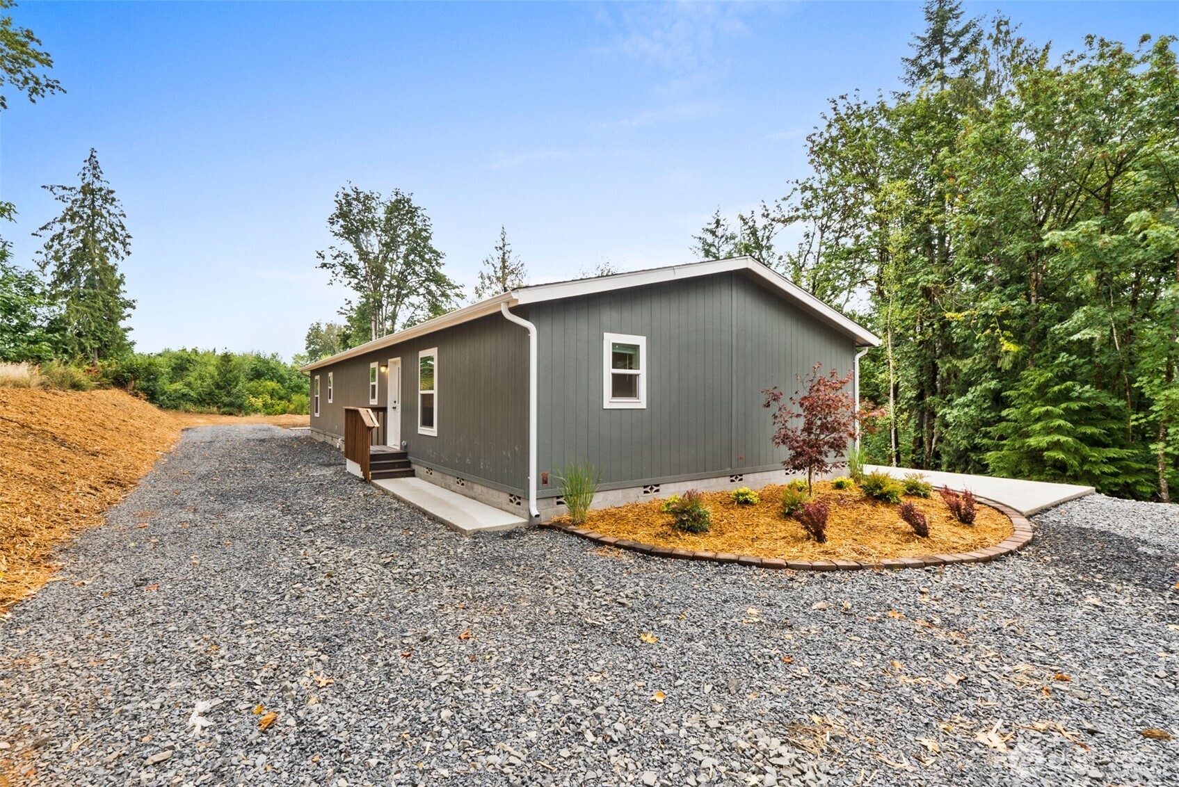 241 Pascoe Avenue Chehalis, WA 98532 - Photo 3 of 33 a backyard of a house with a garden and trees