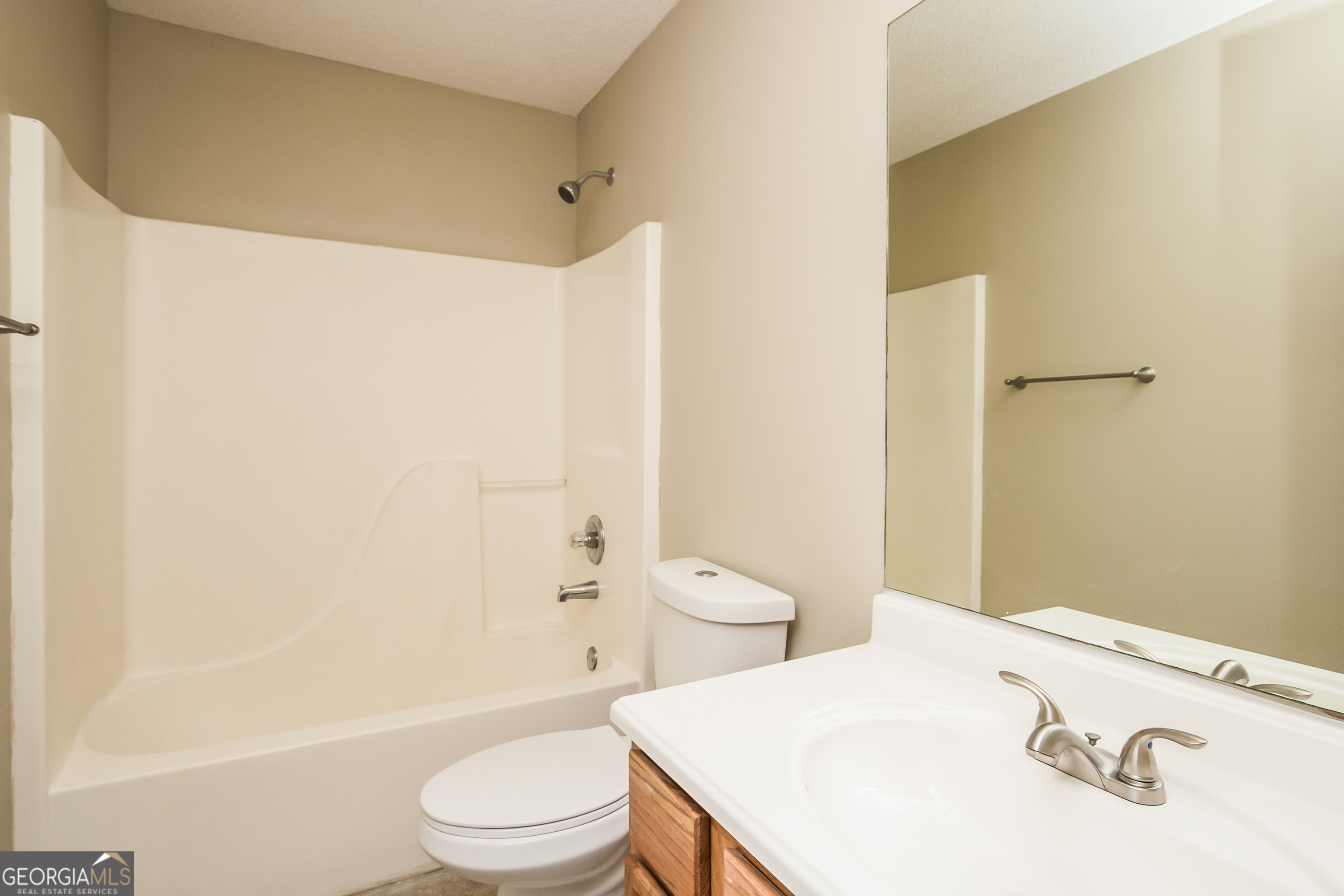 4980 Wolfcreek View South Fulton, GA 30349 - Photo 14 of 15 a bathroom with a sink a toilet and shower