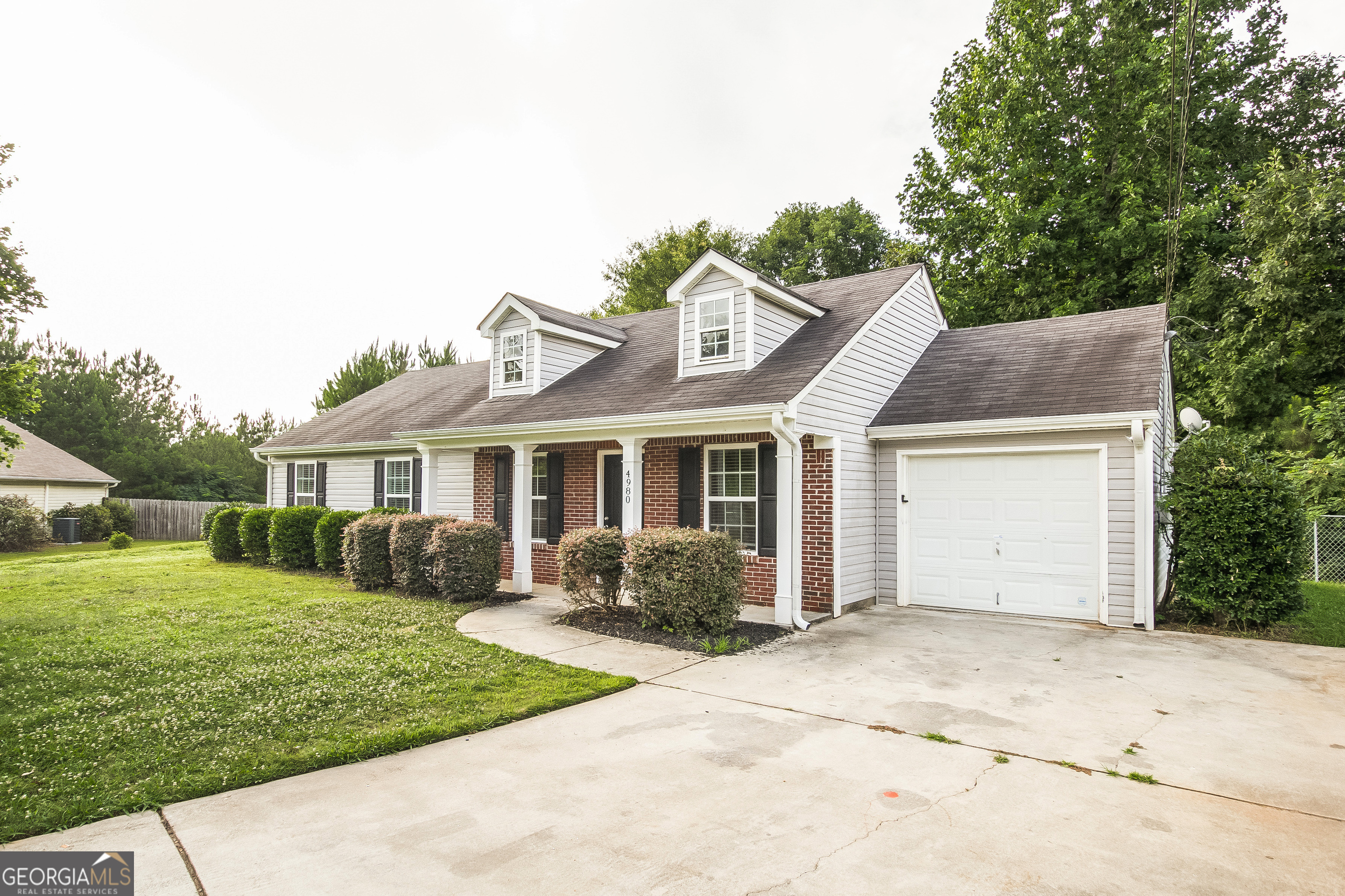 4980 Wolfcreek View South Fulton, GA 30349 - Photo 2 of 15 a front view of a house with garden