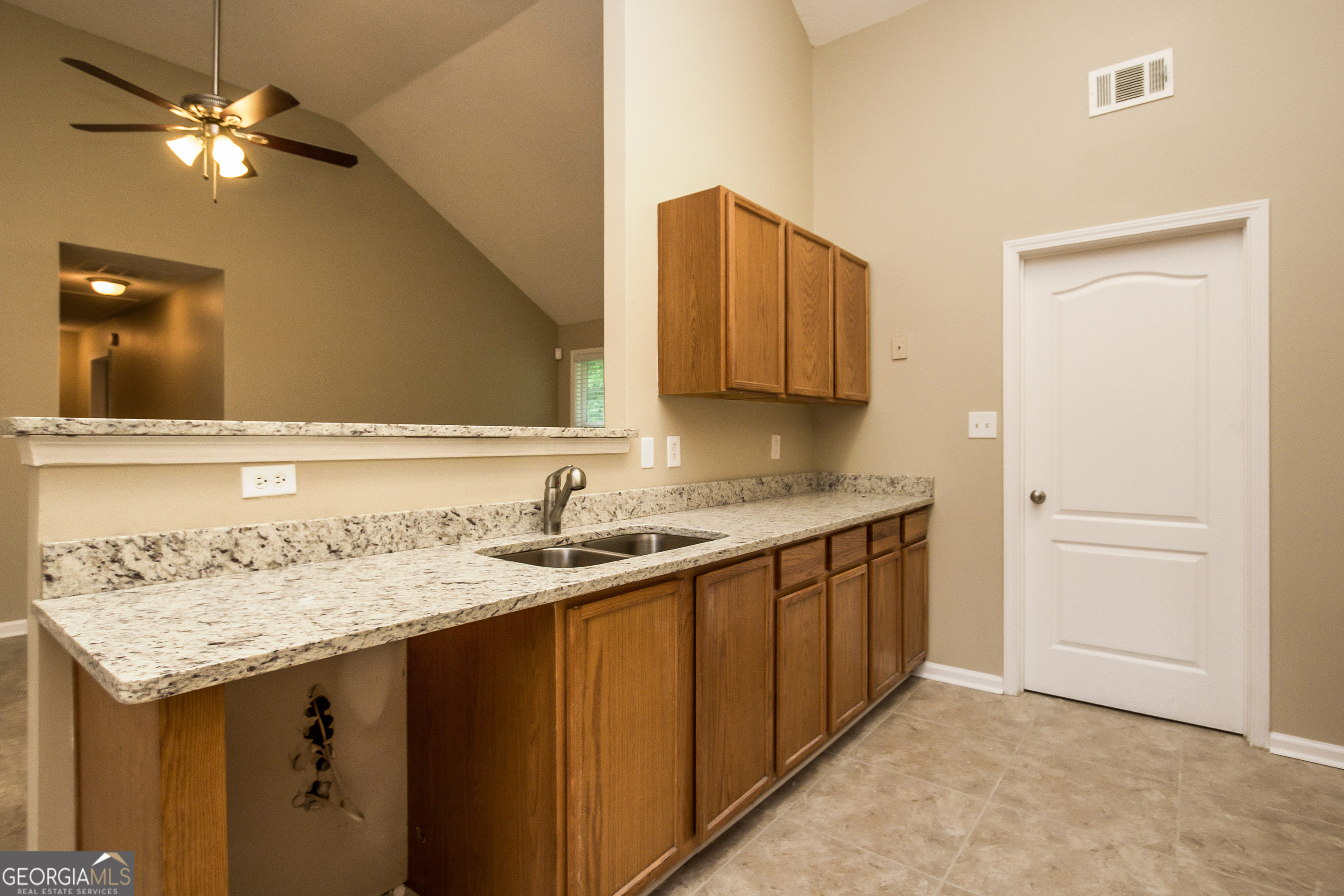 4980 Wolfcreek View South Fulton, GA 30349 - Photo 8 of 15 a kitchen with a sink a cabinetry and a refrigerator