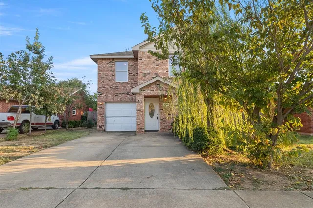 a view of a house with a yard and tree s