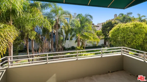 a view of a balcony with trees