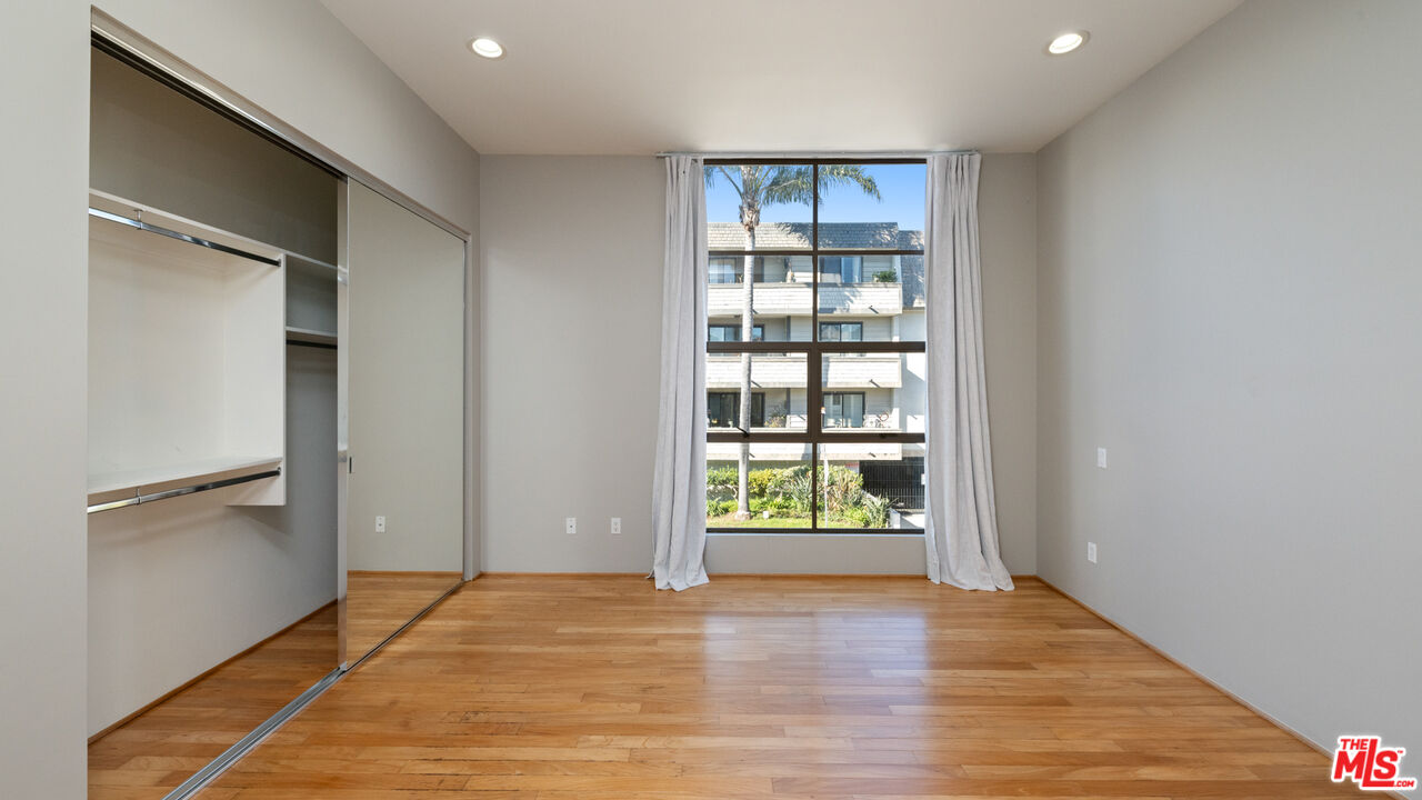 143 Union Jack Mall Marina del Rey, CA 90292 - Photo 22 of 48 an empty room with wooden floor cabinet and windows