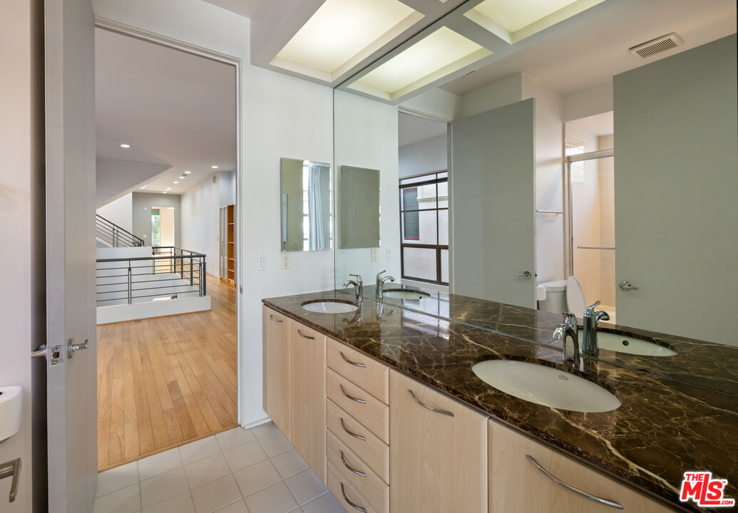 143 Union Jack Mall Marina del Rey, CA 90292 - Photo 23 of 48 a bathroom with a granite countertop sink and a mirror