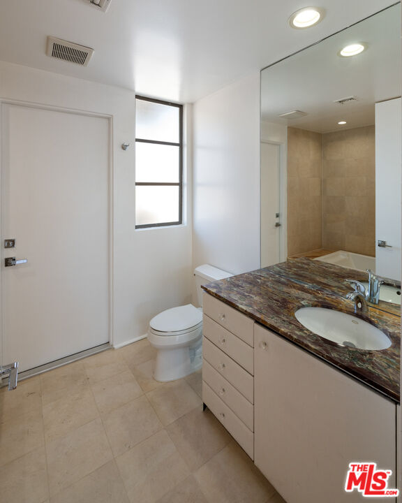 143 Union Jack Mall Marina del Rey, CA 90292 - Photo 27 of 48 a bathroom with a granite countertop sink a toilet and a mirror