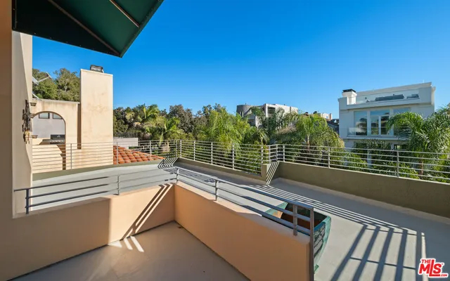 a bathroom with a granite countertop sink a toilet and a mirror