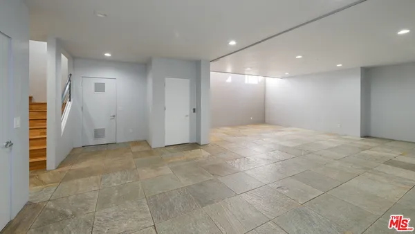 a view of an empty room with a fireplace and a mirror