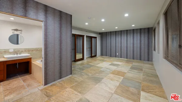 a bathroom with a sink vanity granite and a mirror