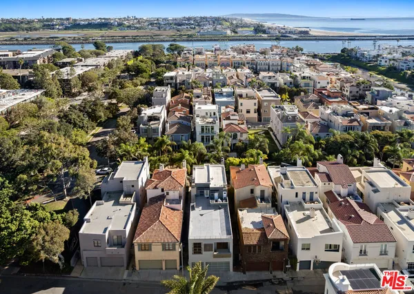 an aerial view of a houses with a city view