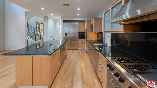 a kitchen with stainless steel appliances granite countertop a stove and a refrigerator