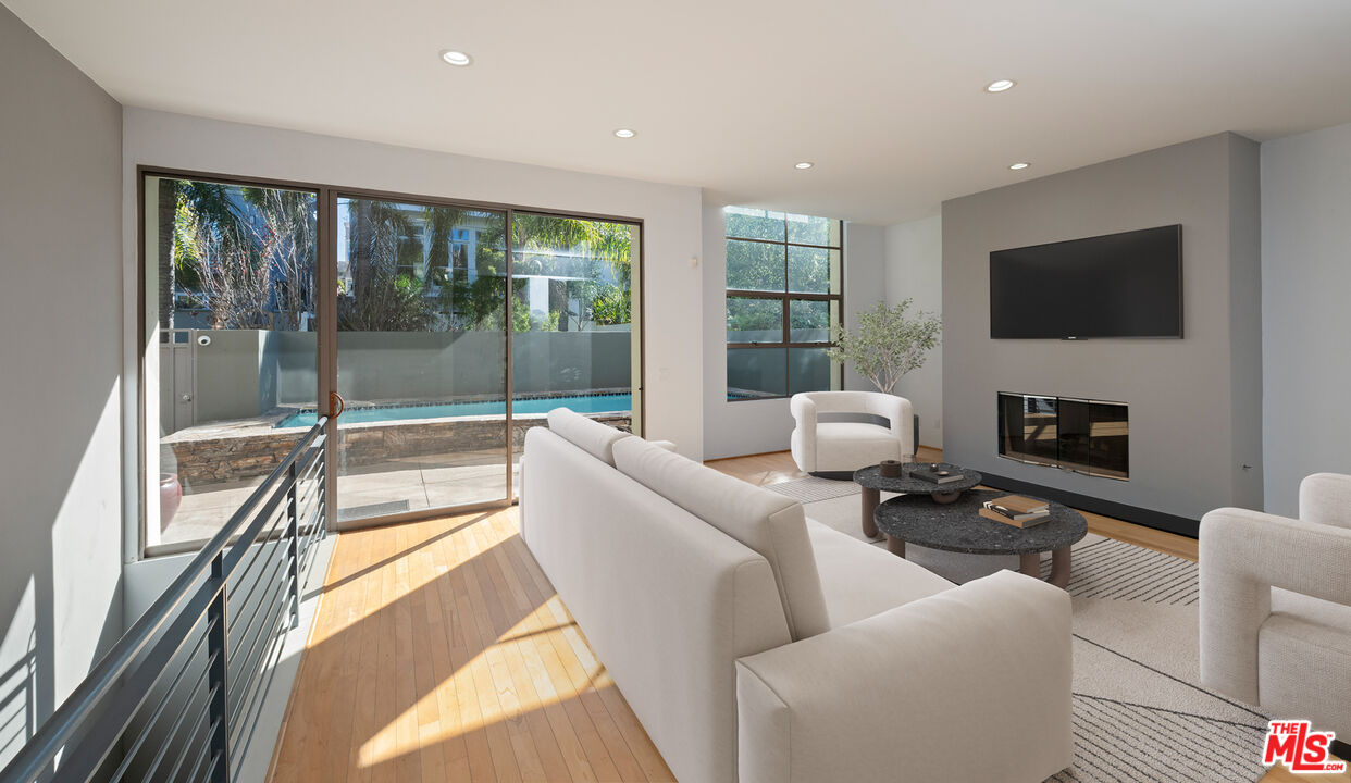 143 Union Jack Mall Marina del Rey, CA 90292 - Photo 7 of 48 a living room with furniture a flat screen tv and a floor to ceiling window
