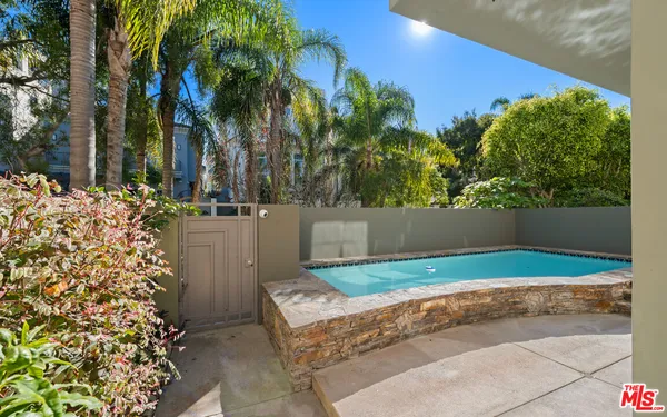 a view of backyard with swimming pool