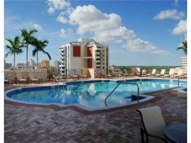 Central Gables Coral Gables, FL 33134 - Photo 2 of 11 a view of a swimming pool with a yard