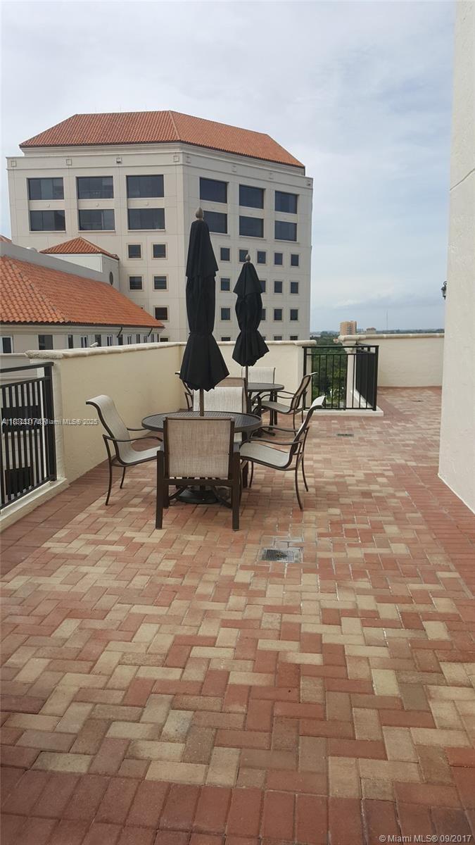 Central Gables Coral Gables, FL 33134 - Photo 3 of 11 a view of a patio with dining table and chairs with wooden fence