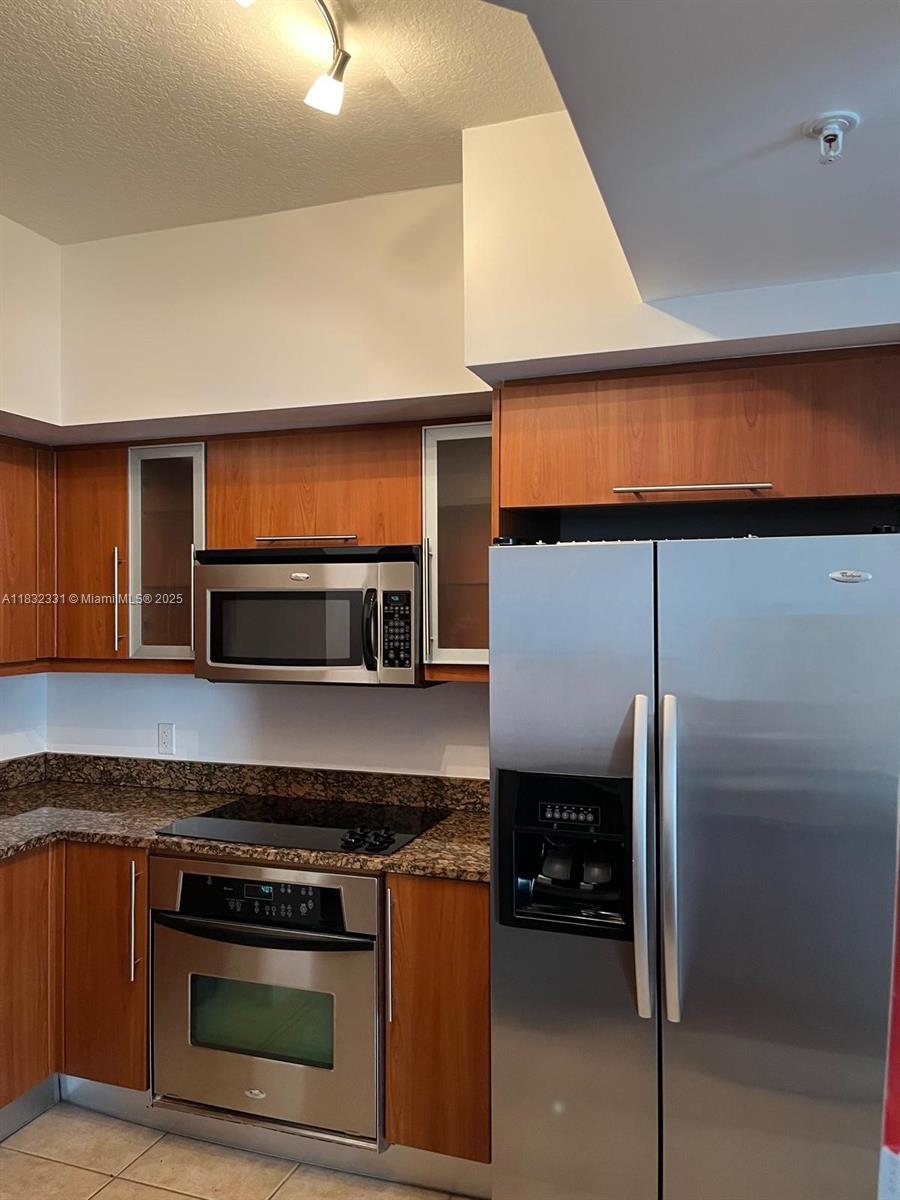 Central Gables Coral Gables, FL 33134 - Photo 6 of 11 a kitchen with a stove and a microwave