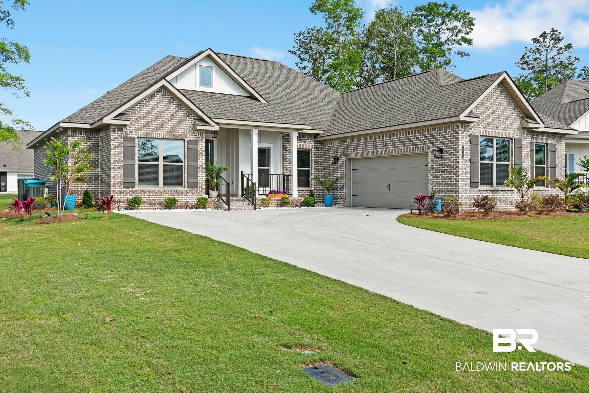 12132 Exbury Way Daphne, AL 36527 - Photo 2 of 47 Craftsman inspired home with a front lawn, brick siding, and roof with shingles