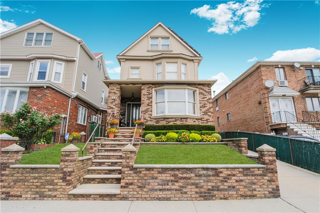 1445 Bay Ridge Parkway Brooklyn, NY 11228 - Photo 1 of 5 a front view of a house with a garden and deck