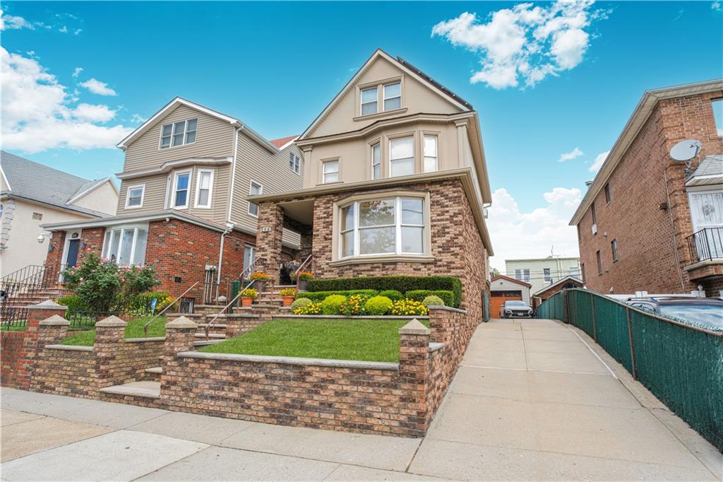 1445 Bay Ridge Parkway Brooklyn, NY 11228 - Photo 3 of 5 a front view of a house with a garden and trees