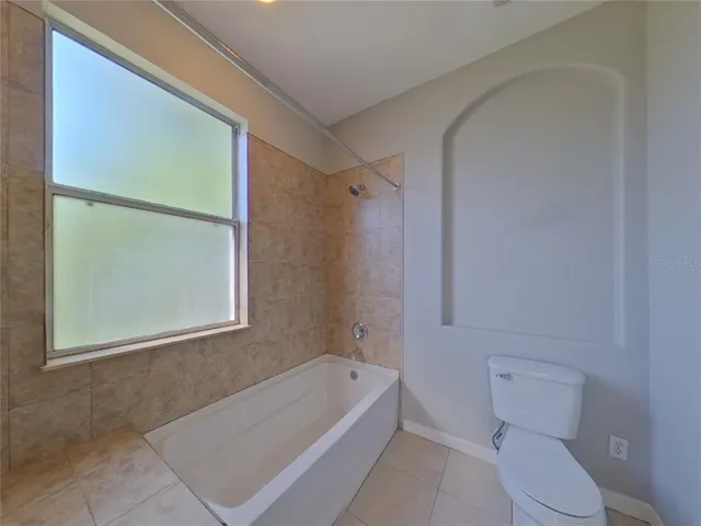 a bathroom with a toilet a bath tub and a shower