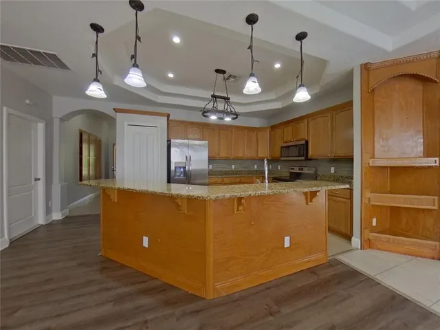 a view of kitchen with refrigerator and window