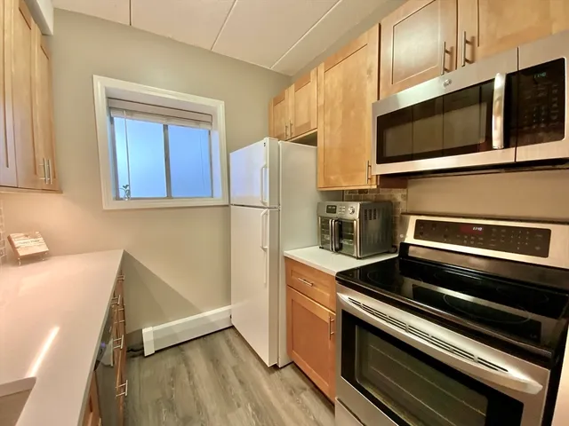 a kitchen with stainless steel appliances and wooden cabinets