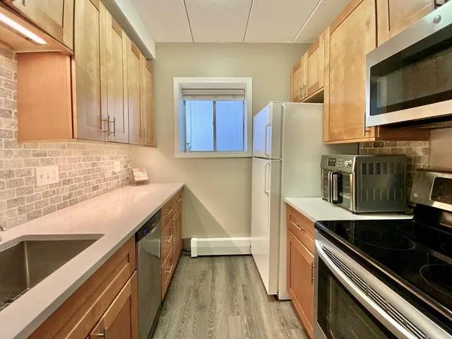 a kitchen with a sink stove and microwave