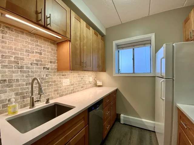 a kitchen with a sink and refrigerator
