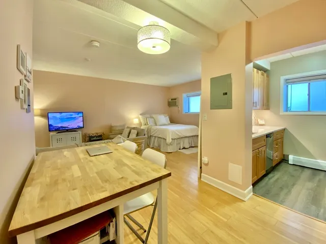 a view of a dining room with furniture and a chandelier