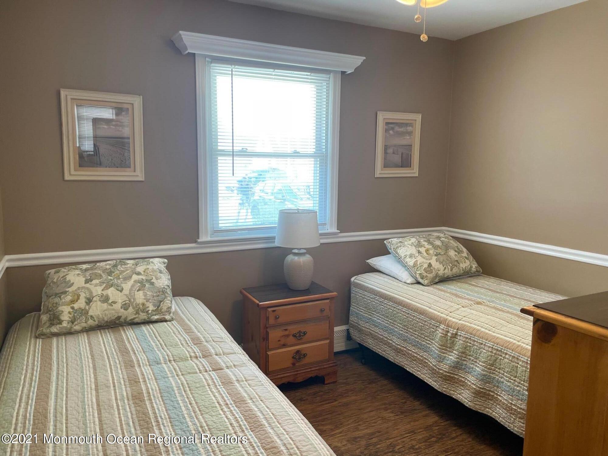 15 Elizabeth Avenue Lavallette, NJ 08735 - Photo 5 of 8 a bedroom with a bed and wooden floor