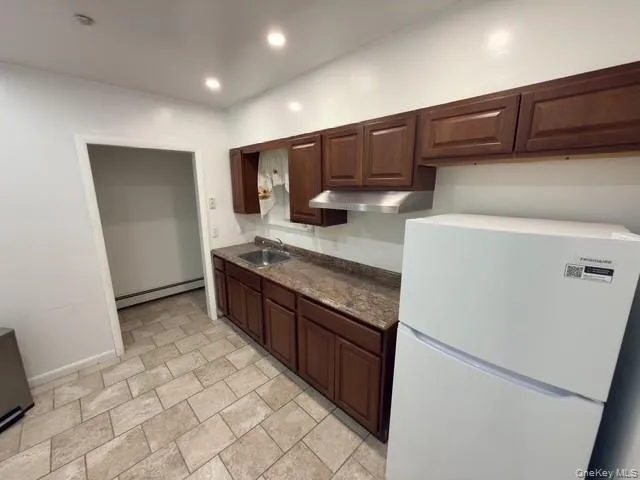 a kitchen with stainless steel appliances granite countertop a refrigerator and a stove